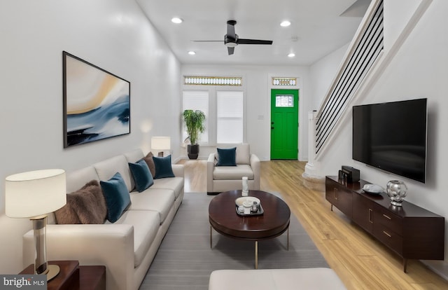 living room featuring ceiling fan and light hardwood / wood-style flooring