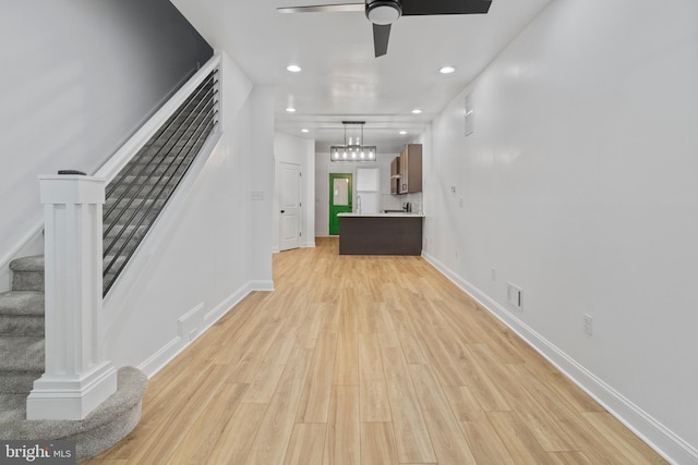 interior space featuring light hardwood / wood-style floors and ceiling fan