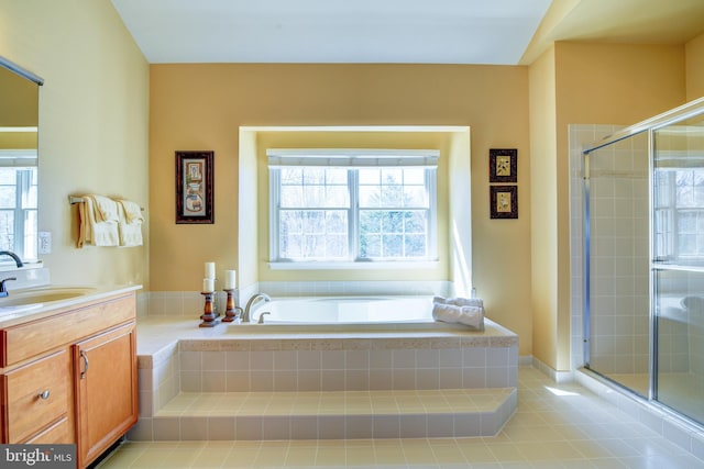 bathroom with tile patterned floors, a garden tub, a stall shower, and vanity