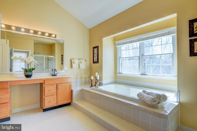 full bathroom with a shower stall, tile patterned flooring, a bath, vanity, and vaulted ceiling