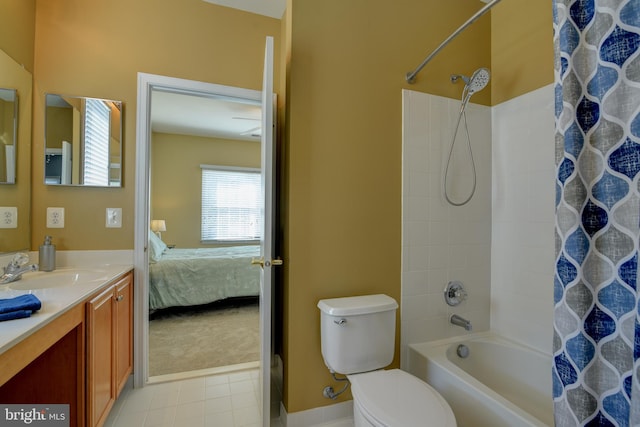 ensuite bathroom featuring tile patterned floors, shower / bath combo with shower curtain, toilet, ensuite bathroom, and vanity