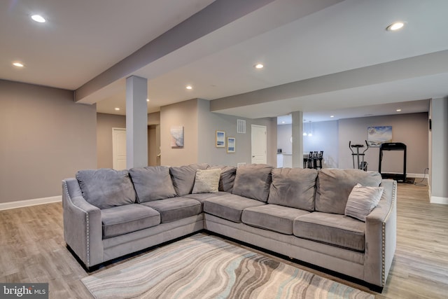 living area featuring recessed lighting, visible vents, baseboards, and light wood-style floors