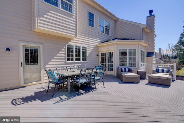 deck with an outdoor living space and outdoor dining space