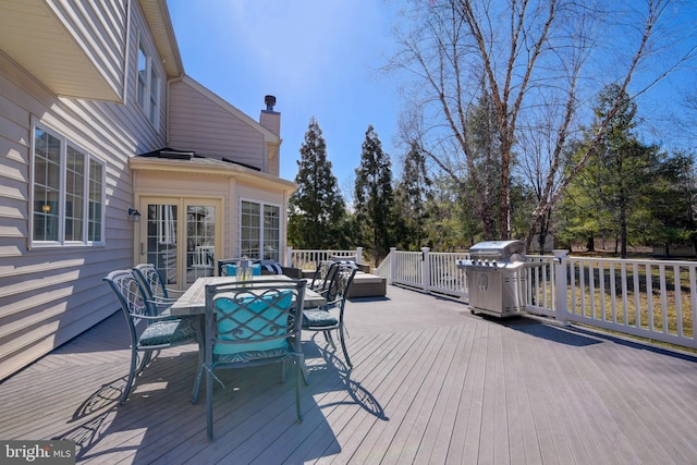 wooden deck featuring outdoor dining space