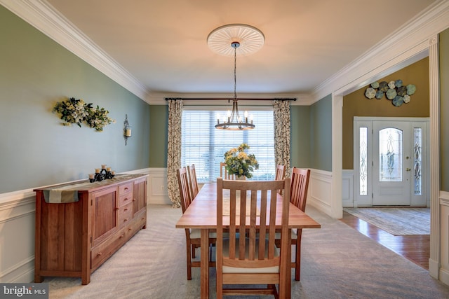 dining area with a wealth of natural light, a chandelier, and crown molding