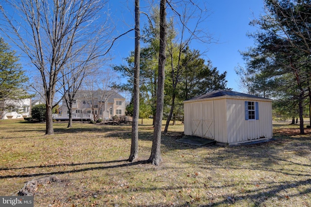 view of yard featuring a storage unit and an outbuilding