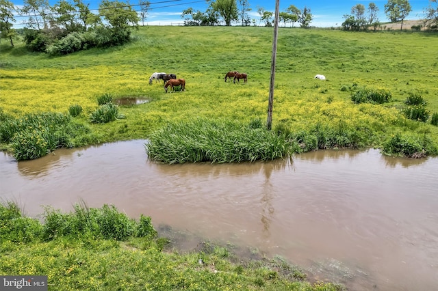 exterior space featuring a water view and a rural view