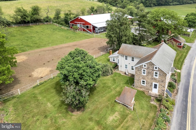 birds eye view of property with a rural view