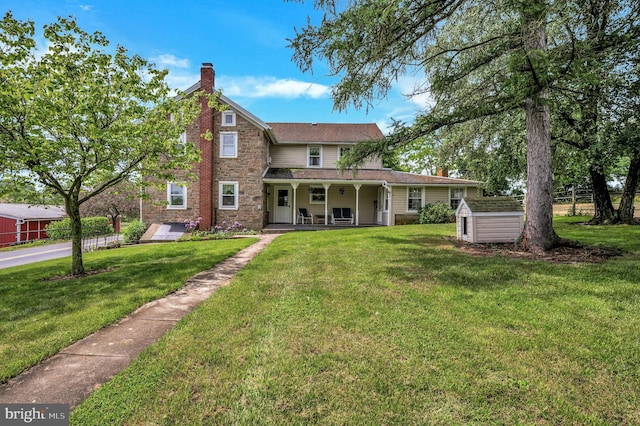 rear view of property featuring a yard