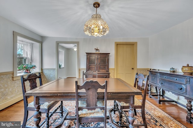 dining room featuring light wood-type flooring and a notable chandelier