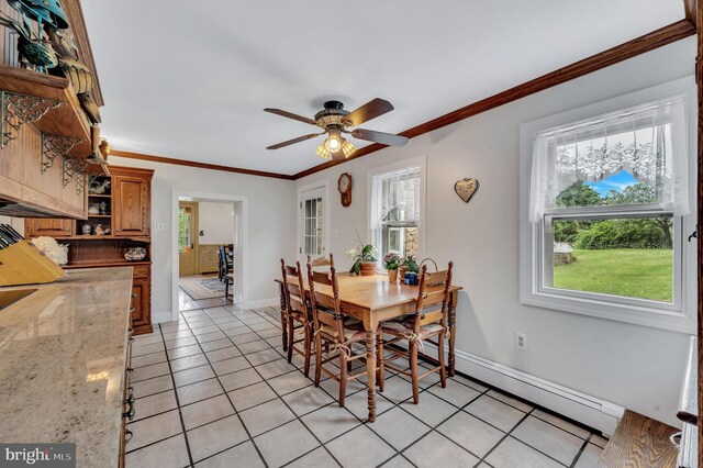 dining room featuring ceiling fan, light tile patterned flooring, baseboard heating, and crown molding