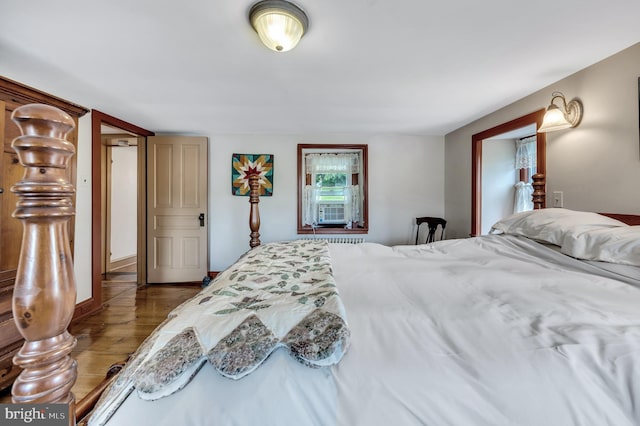 bedroom with cooling unit and wood-type flooring