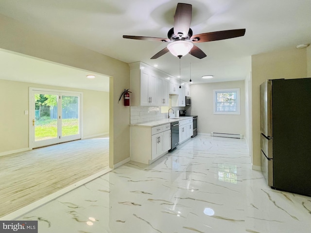 kitchen featuring white cabinets, a healthy amount of sunlight, appliances with stainless steel finishes, and tasteful backsplash