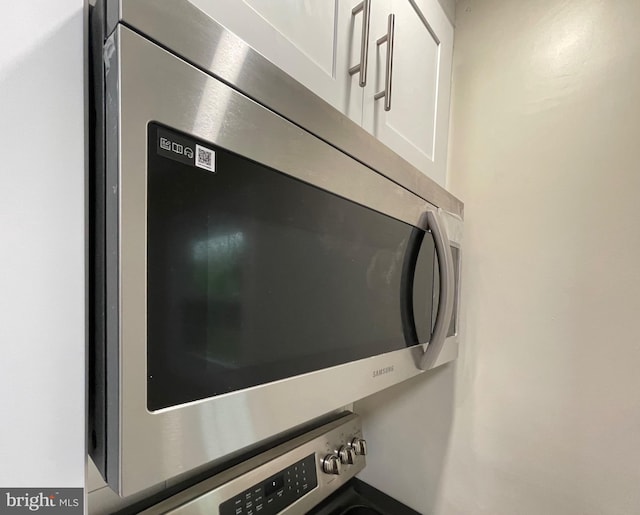 interior details featuring white cabinetry and appliances with stainless steel finishes