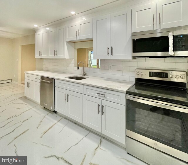 kitchen with sink, decorative backsplash, light stone countertops, white cabinetry, and stainless steel appliances