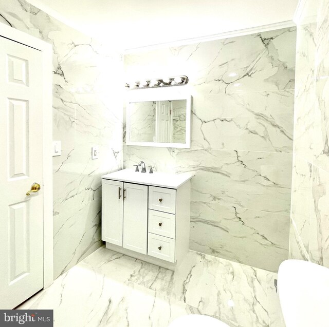 bathroom with vanity, tile walls, and toilet