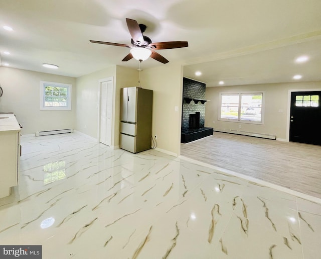 unfurnished living room featuring ceiling fan, a baseboard radiator, and a brick fireplace