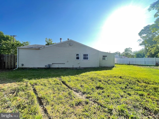 rear view of house with a yard