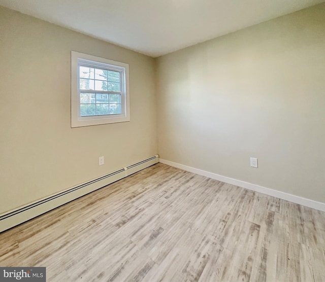 spare room featuring light hardwood / wood-style flooring and a baseboard radiator