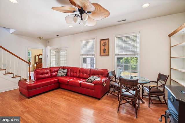 living room with hardwood / wood-style flooring and ceiling fan