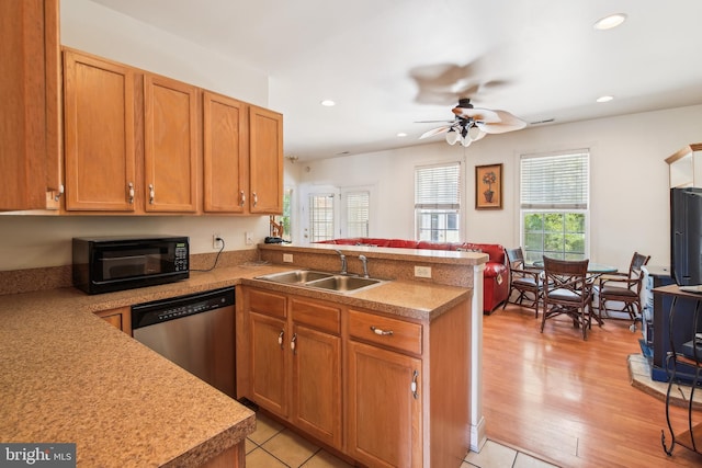 kitchen featuring dishwasher, sink, ceiling fan, light wood-type flooring, and kitchen peninsula