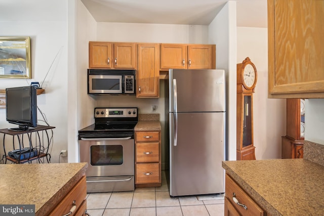 kitchen featuring appliances with stainless steel finishes and light tile patterned flooring