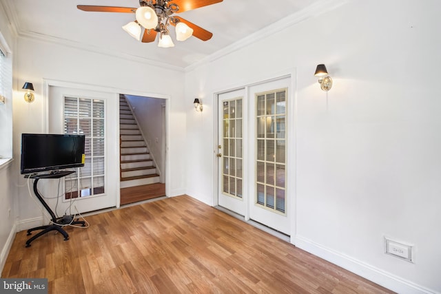 interior space featuring ceiling fan, light hardwood / wood-style flooring, and ornamental molding