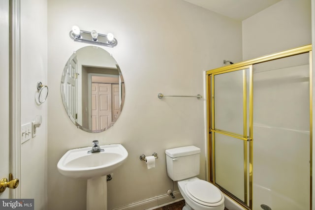 bathroom with toilet and walk in shower