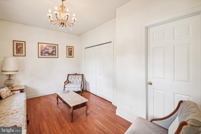 living area with a notable chandelier and wood-type flooring