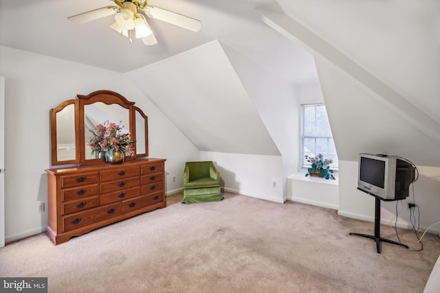 interior space with ceiling fan, light carpet, and vaulted ceiling