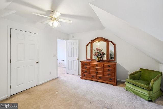 living area featuring ceiling fan, lofted ceiling, and light carpet