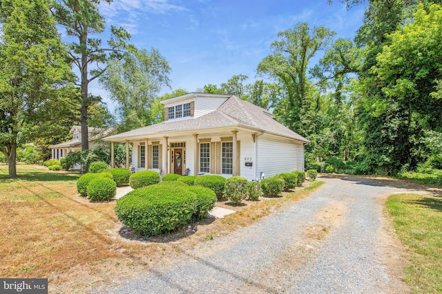 view of front of property with covered porch and a front lawn