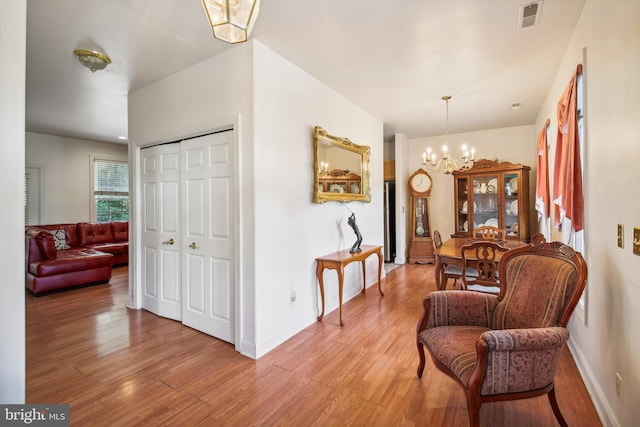 interior space featuring an inviting chandelier and light wood-type flooring