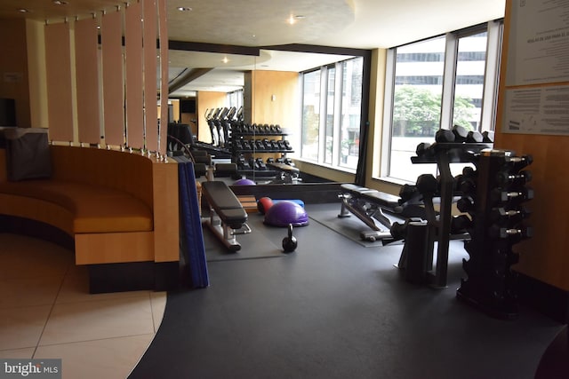 exercise room with tile patterned floors