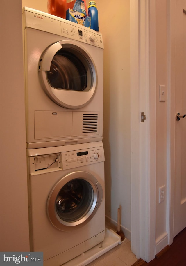 laundry room with stacked washer / drying machine