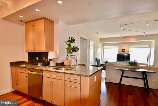 kitchen with backsplash, dishwasher, dark hardwood / wood-style floors, sink, and light brown cabinetry