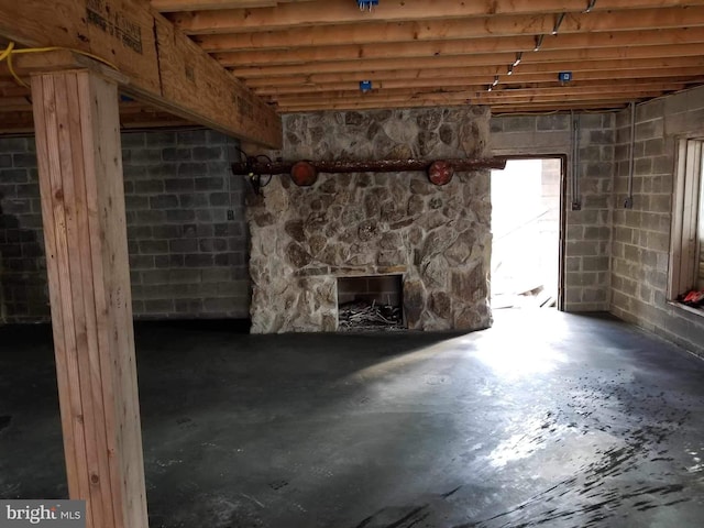 basement featuring a stone fireplace