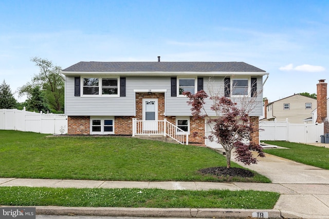 bi-level home with a front yard