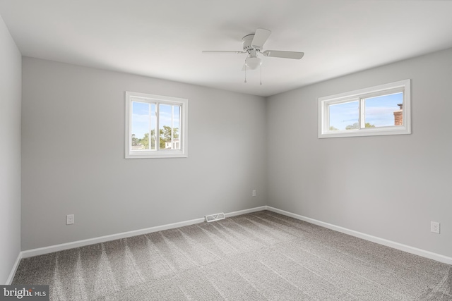 unfurnished room with carpet flooring and ceiling fan