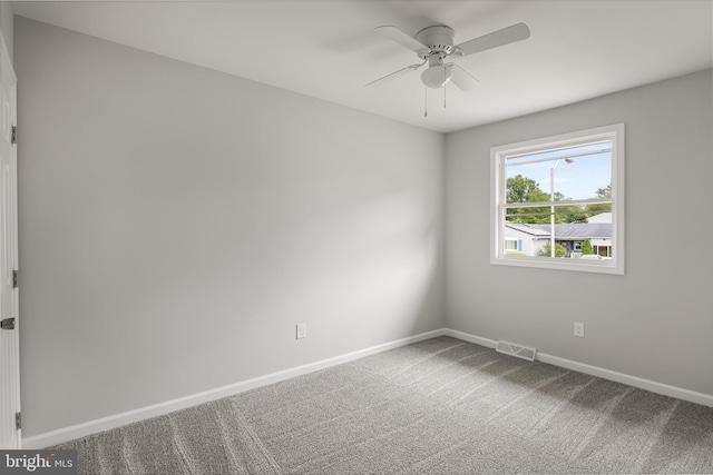 carpeted empty room featuring ceiling fan