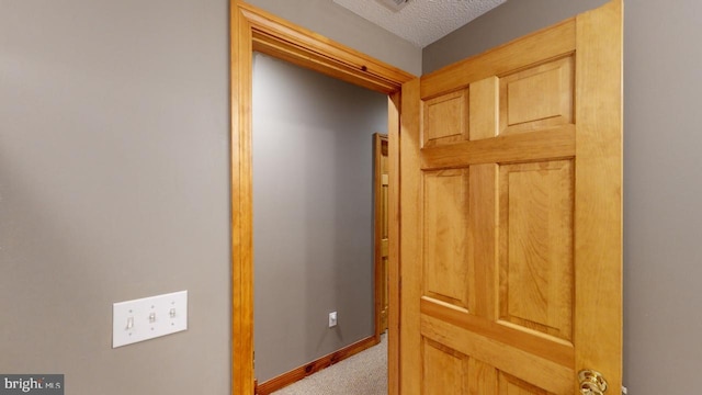 corridor with a textured ceiling