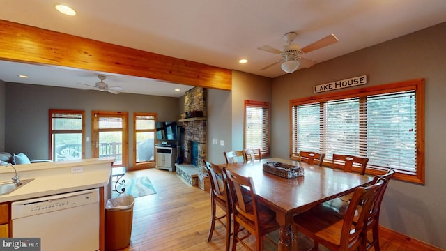 dining area featuring ceiling fan, light wood-type flooring, and sink