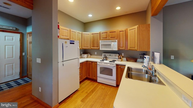 kitchen featuring light hardwood / wood-style flooring, white appliances, and sink