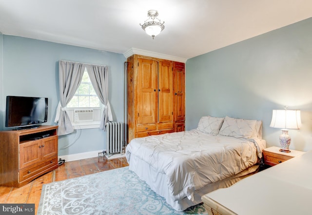 bedroom featuring radiator heating unit and light hardwood / wood-style floors