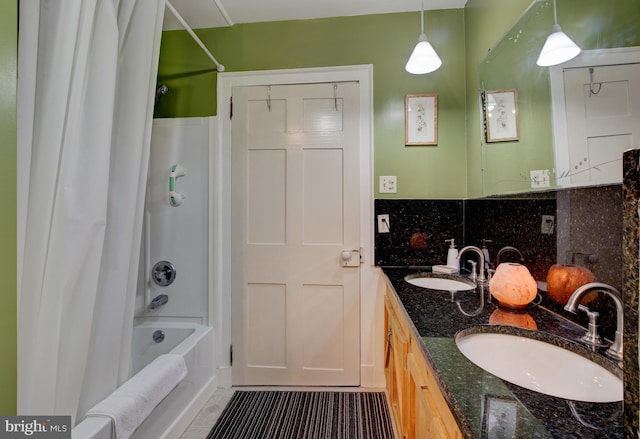 bathroom with shower / bathing tub combination, vanity, and tasteful backsplash