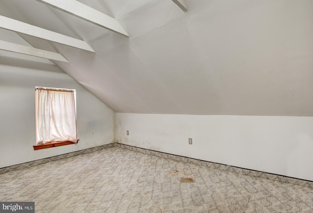 bonus room with lofted ceiling and carpet floors