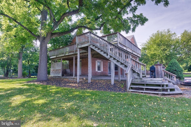 rear view of house with a lawn and a deck