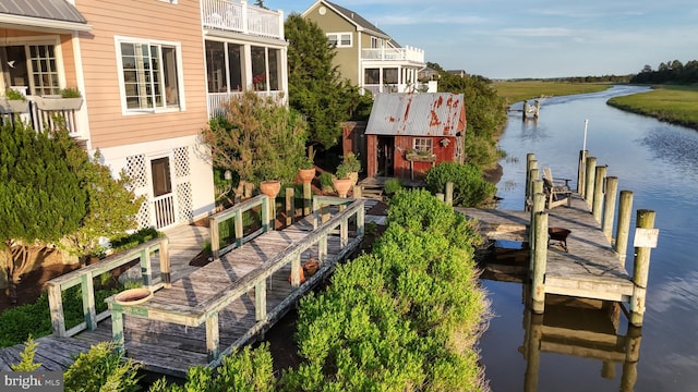 exterior space with a balcony and a water view