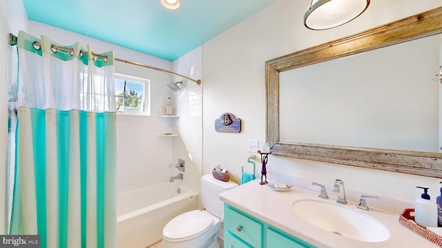 full bathroom featuring shower / tub combo, vanity, and toilet