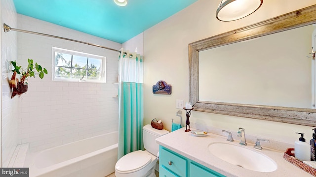 full bathroom featuring vanity, shower / bathtub combination with curtain, and toilet